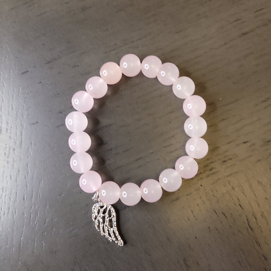 Light pink beaded bracelet with wing charm