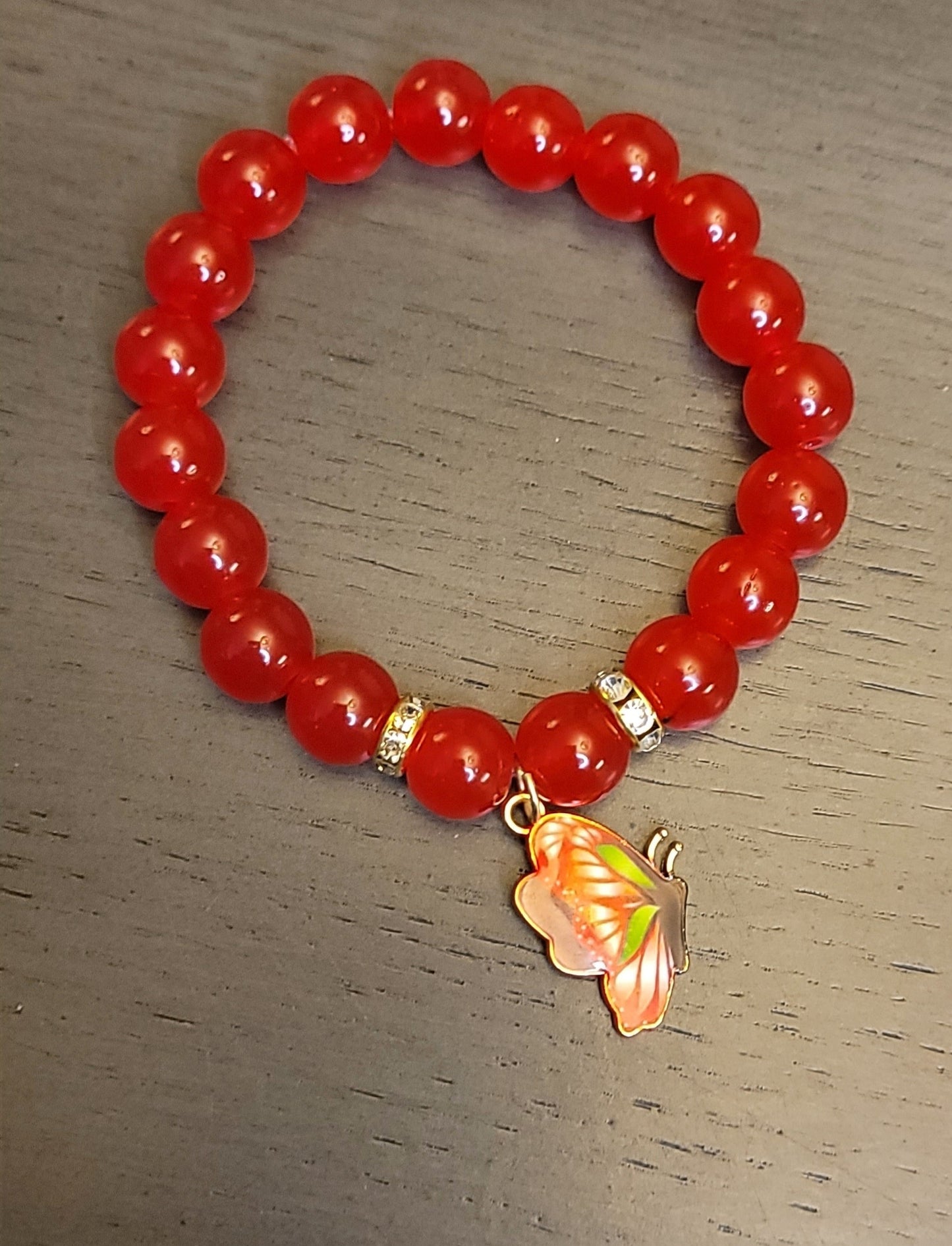 Red beaded stretch bracelet w/ butterfly charm