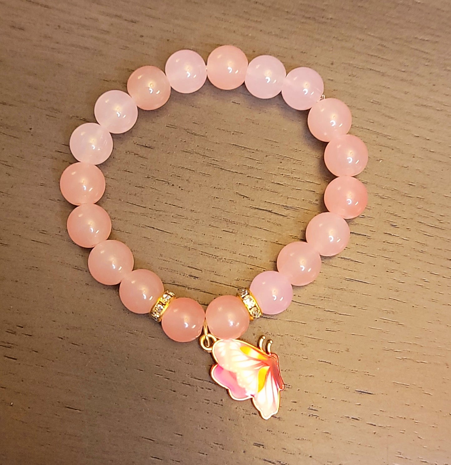 Pink bead bracelet w/ butterfly charm